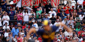 Fans hold a “Sweet Caroline” sign during the eighth inning stretch of the game between the Milwaukee Brewers and the Boston Red Sox at Fenway Park on May 25,2024 in Boston.