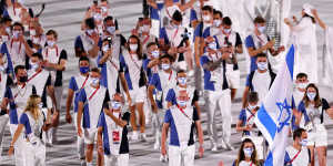 Hanna Minenko and Yakov Toumarkin of Team Israel lead their team during the Opening Ceremony of the Tokyo 2020 Olympic Games at Olympic Stadium in 2021.