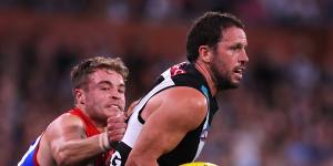 Kade Chandler of the Demons tackles Travis Boak of the Power.