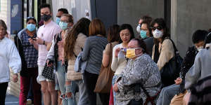People wait outside the Royal Melbourne Hospital to be tested for coronavirus at a screening clinic on Tuesday.