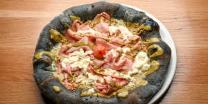 Mortadella pizza on a charcoal dough base.