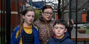 Vicky Young,with children Charlotte and William,outside St John’s Primary School in Clifton Hill.