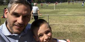 Greens MP Michael Berkman with his son,Noah,at a junior football match. 