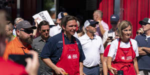 Ron DeSantis flips pork burgers at the Iowa Pork Producers tent at the Iowa State Fair.