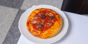 Ligurian-style pizzette topped with tomato,olives,capers and anchovies.