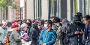 People line up outside a Melbourne Centrelink office at the height of the pandemic in 2020. Fiscal stimulus unleashed during the period will be felt in the economy until 2025,new research shows. 