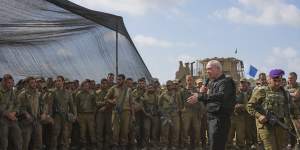 Israeli Defence Minister Yoav Gallant speaks to Israeli soldiers in a staging area near the border with Gaza.