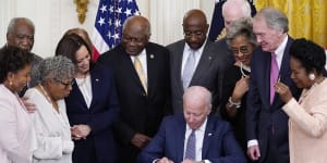 President Joe Biden signs the bill in the East Room of the White House.