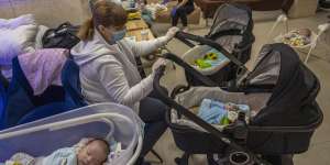 Nannies take care of newborn babies in a basement converted into a nursery in Kyiv.