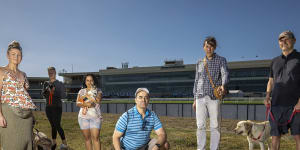 Anaru August with dog Baxter and other Caulfield dog-walking locals concerned about what Melbourne Football Club’s shift to the racecourse will mean for public use.