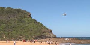 A search is under way for a 15-year-old boy swept off a rock shelf at North Avoca Beach on Tuesday.