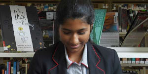 Amisha Guta 16yrs reading in the library at Queenwood school in Mosman.