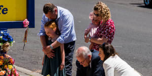 Prime Minister Scott Morrison says a prayer alonside wife Jenny at Hillcrest Primary School on Saturday. With them is member for Braddon Gavin Pearce.