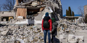 People look at the remains of a school hit by Russian missiles in Zhytomyr,Ukraine,