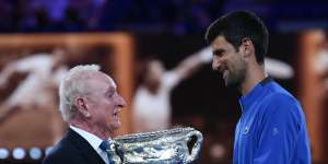 Novak Djokovic presents Laver with a trophy to mark the 50th anniversary of his second Grand Slam on January 14,2019.