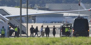 Passengers,including one believed to be Dr Moore-Gilbert,leave a government jet at Canberra Airport in November 2020.