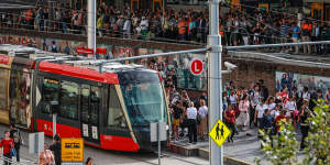 Commuters attempt to board Sydney’s light rail. 