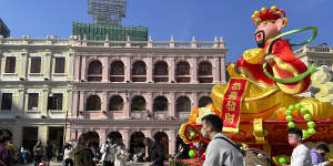 Travellers from mainland China walk around Senado Square,a tourist destination in Macao,on Wednesday.