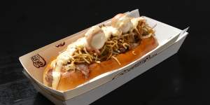 The Paco hot dog topped with melted mozzarella,pineapple sauce,“pink sauce”,matchstick potato crisps and quail eggs.