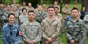 Welcome,China:defence personnel from Australia,the US,New Zealand and China who joined a multinational task group led by the NZ Defence Force and undertook community projects in Tonga in 2016. 
