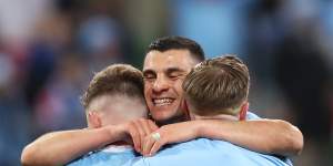 Andrew Nabbout celebrates with his City teammates Scott Galloway and Craig Noone at the stroke of full-time.