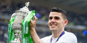 Hero:Tom Rogic lifts the Scottish Cup after scoring the injury-time winner for Celtic against Aberdeen.