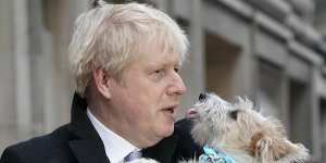 Then British PM Boris Johnson poses after casting his vote with dog Dilyn,in London in 2019.