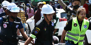 An injured demonstrator is carried away amid the initial protests against the military takeover.