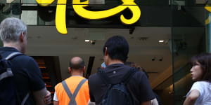 Customers line up outside an Optus shop front during a network outage in Sydney on Wednesday
