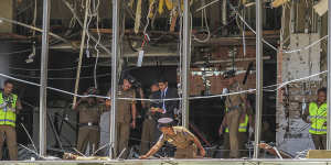 Sri Lankan police inspect the scene at the Shangri-la hotel in Colombo.