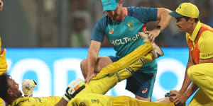 Glenn Maxwell comes in for some medical attention during his miracle innings.