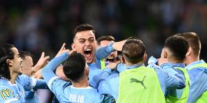 Scott Galloway of Melbourne City celebrates with his teammates after scoring their third goal during the A-League grand final.