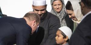 Prince William,left,meets a young Muslim and New Zealand Prime Minister Jacinda Ardern,second right,at the Al Noor mosque in Christchurch in six weeks after the attacks.