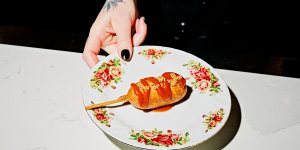 Plant-based corn dog with golden curry ketchup and mustard seeds at Smith + Daughters Social Club.