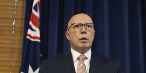 Opposition Leader Peter Dutton during a press conference in July,flanked by the Australian flag.