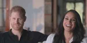 Harry and Meghan laughing in this screenshot from the Harry&Meghan documentary.