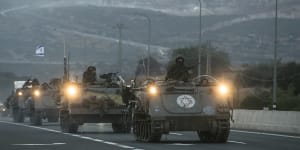 Israeli armoured personnel carriers move in formation near the border with Lebanon.