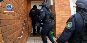 Anti-gang police storm a house in Ryde to arrest Shane Lindsay,who police allege was involved in car thefts for Sydney’s underworld.
