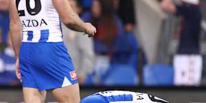 North Melbourne players accept the hollow feeling of a draw.,