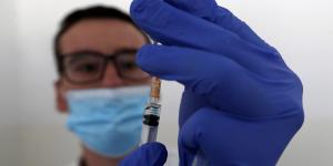 A medical worker prepares to administer a dose of the AstraZeneca vaccine.