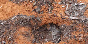 Inspectors discovered waste buried beneath orange-coloured gravel.
