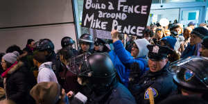 Protesters are surrounded by police at John F. Kennedy airport in New York.