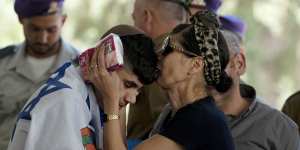 Harel Elias is kissed by his mother,Shlomit,on Friday after giving a eulogy at the funeral for his brother,Israeli Army Sargent Yonatan Elias,who was killed in bettle in the Gaza Strip.