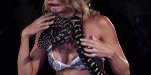 Kristy Hinze models a live python and a $1 million diamond-encrusted bikini at Jodhi Meares'Tigerlily runway show.
