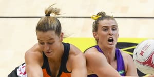 Giant Jamie-Lee Price (left) fights for the ball with Gabi Simpson of the Firebirds on Sunday.