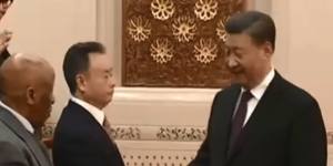 Businessman Chau Chak Wing shakes hands with Chinese President Xi Jinping during a meeting of global leaders in Beijing.