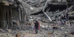People inspect the damage and extract items from their homes in Khan Younis,in the south of the Gaza Strip.