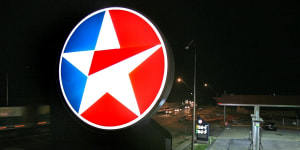 Caltex has had a bad six months due to sluggish consumer spending and falling refinery margins.