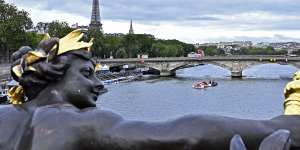A boat pulls out of the starting line in front of the Eiffel Tower after the cancellation of the Open Water Swimming World Cup on August 6.