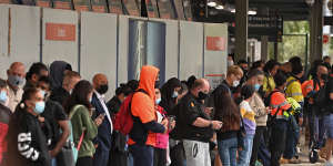 Commuters wait for the train at Central station as strike action causes significant delays across the network.